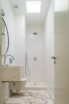 a white bathroom with a sink and a shower at Modern & Cozy Faro Mercado Apt 21 by Lisbeyond in Faro