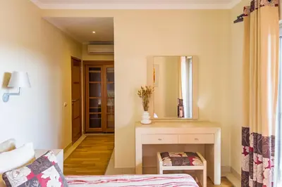 a bedroom with a desk and a mirror at Beautiful Family T3 Townhouse with Pool Vilamoura in Vilamoura