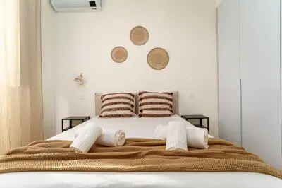 a bedroom with a large bed with towels on it at Modern & Bright - Faro Mercado Apt 22 by Lisbeyond in Faro