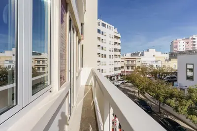 an apartment balcony with a view of a city at Modern & Bright - Faro Mercado Apt 22 by Lisbeyond in Faro