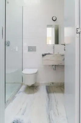 a white bathroom with a toilet and a sink at Modern & Bright - Faro Mercado Apt 22 by Lisbeyond in Faro