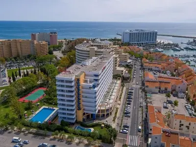 an aerial view of a city with buildings and the ocean at Newly refurbished 2 bed appt Vilamoura in Vilamoura