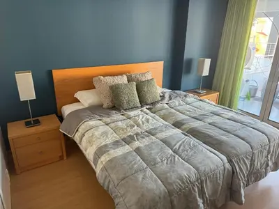 a bedroom with a large bed with two lamps at Newly refurbished 2 bed appt Vilamoura in Vilamoura