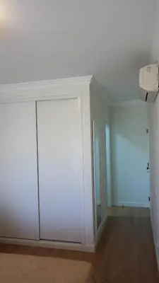 an empty room with white walls and a closet at Vila Atlantida Apartment in Vilamoura