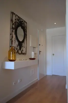 a white room with a mirror and a door at Vila Atlantida Apartment in Vilamoura