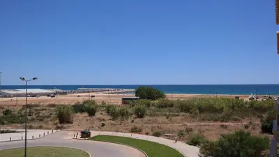 a view of a beach with the ocean in the background at Vila Atlantida Apartment in Vilamoura