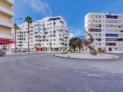 a statue of a dinosaur in the middle of a street at AL - Apartamento Quarteira Avenida in Quarteira