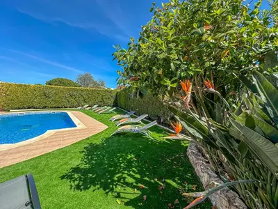 a garden with lounge chairs and a swimming pool at Luxury Holiday Villa Pescadinha near Beach, Albufeira in Albufeira