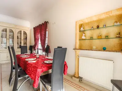 a dining room with a table and a fireplace at Luxury Holiday Villa Pescadinha near Beach, Albufeira in Albufeira
