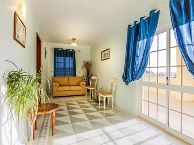 a living room with blue curtains and a couch at Luxury Holiday Villa Pescadinha near Beach, Albufeira in Albufeira