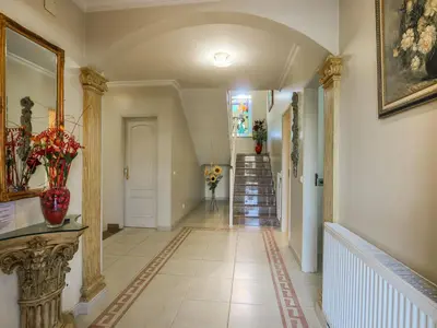 a hallway with a staircase and a vase of flowers at Luxury Holiday Villa Pescadinha near Beach, Albufeira in Albufeira