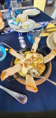 a table with a plate of food on a table at Apartamentos Mar-Bel Sol in Vilamoura