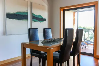 a dining room with a table and chairs at Apartamento Panoramico - By Dalma Portuguesa in Albufeira