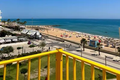 a view of a beach and the ocean from a balcony at TOM's House - T2 Sea View in Quarteira