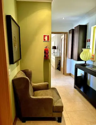 a living room with a chair and a fire hydrant at TOM's House - T2 Sea View in Quarteira