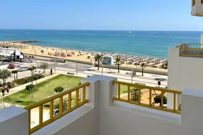 a view of the beach from the balcony of a building at TOM's House - T2 Sea View in Quarteira