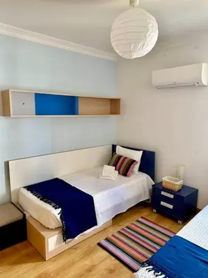 a bedroom with a large bed with a blue and white at TOM's House - T2 Sea View in Quarteira