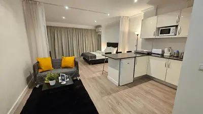 a small living room with a couch and a kitchen at Original Studio Downtown in Albufeira