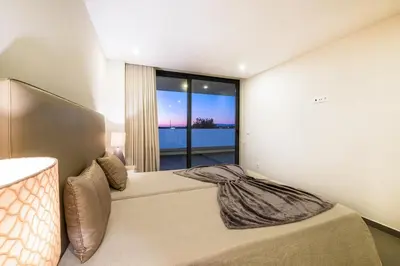 a bedroom with a large bed with a large window at Villa Aboim - BY BEDZY in Guia
