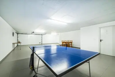 a ping pong table in the middle of a room at Villa Aboim - BY BEDZY in Guia
