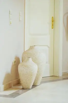 a couple of vases sitting in front of a door at Suites & Beds DP Albufeira in Albufeira