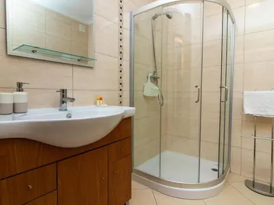 a bathroom with a sink and a glass shower at Magnólia AB House by Stay ici Algarve Holiday Rental in Albufeira