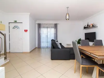 a living room with a couch and a table at Magnólia AB House by Stay ici Algarve Holiday Rental in Albufeira