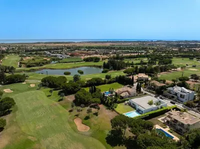 an aerial view of the golf course at a resort with a lake at Villa Laguna 25 by Stay ici Algarve Holiday Rental in Quarteira