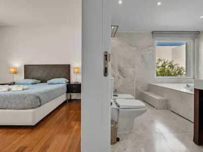 a bedroom with a bed and a tub and a sink at Villa Laguna 25 by Stay ici Algarve Holiday Rental in Quarteira