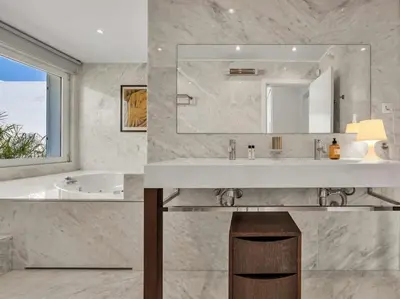 a bathroom with a sink and a tub and a mirror at Villa Laguna 25 by Stay ici Algarve Holiday Rental in Quarteira
