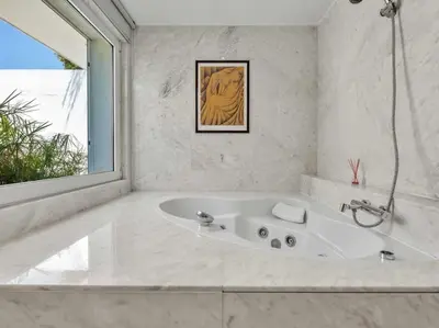 a white bathroom with a tub and a window at Villa Laguna 25 by Stay ici Algarve Holiday Rental in Quarteira