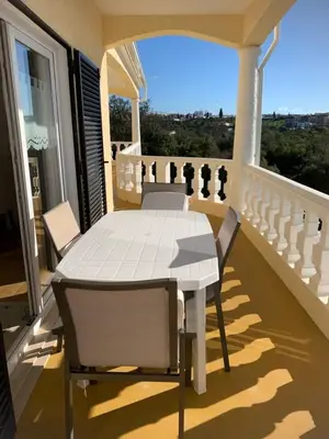 a white table and chairs on a balcony at Casa Amar in Loulé