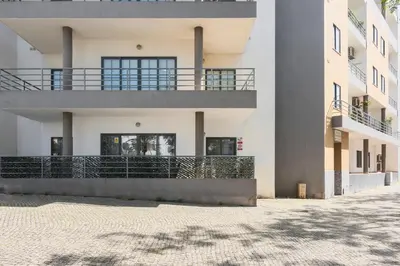 a building with a balcony on the side of it at Roberto Quarteira Central in Quarteira