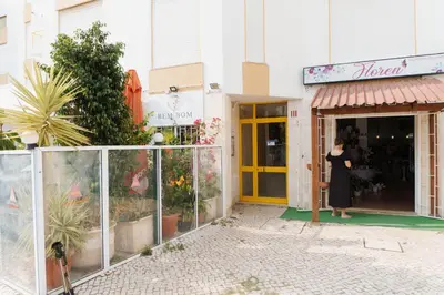 a woman standing in the doorway of a store at Happy House in Quarteira