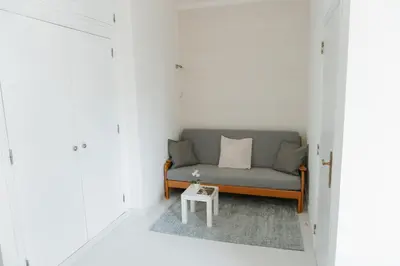 a living room with a couch and a table at Happy House in Quarteira