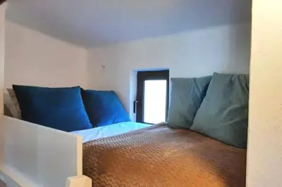 a bed with blue pillows in a room at Excellent 1 Bedroom Villa - em Clube Albufeira Garden Village in Albufeira
