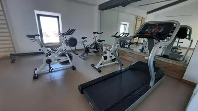 a gym with several exercise bikes in a room at Excellent 1 Bedroom Villa - em Clube Albufeira Garden Village in Albufeira