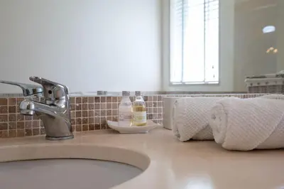 a bathroom counter with a sink and a faucet at Palmyra by Intiholidays in Vilamoura