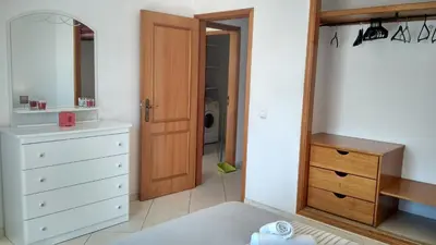 a bedroom with a white dresser and a mirror at Apartamentos Monica in Quarteira