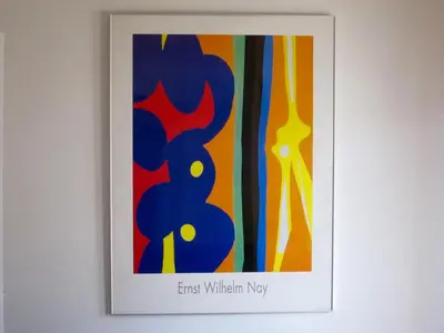 a framed picture of a colorful painting on a wall at Quarteira Paul Harris Apartment in Quarteira