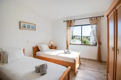two beds in a room with a window at Welcoming Oasis 500m Beach AC Wi-Fi Pool Balcony in Albufeira