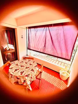 a room with a table and a large window at Point Apartament Praia da Oura in Albufeira