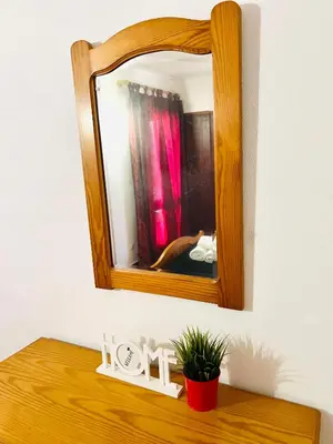 a mirror sitting on top of a wooden table at Point Apartament Praia da Oura in Albufeira