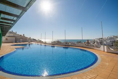 a large swimming pool on top of a building at Colibri by HelloVacations in Albufeira