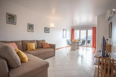 a living room with a couch and a table at Colibri by HelloVacations in Albufeira
