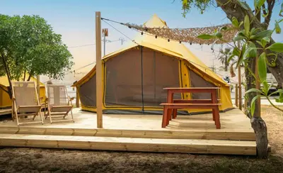 a tent with a wooden deck in front of it at Glamping Camp Faro in Faro