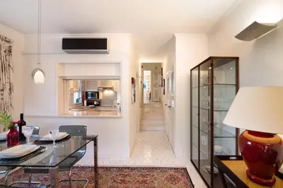 a living room with a table and a kitchen at Bia in Almancil