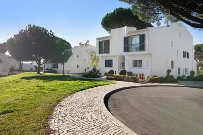 a large white house with a driveway at Bia in Almancil