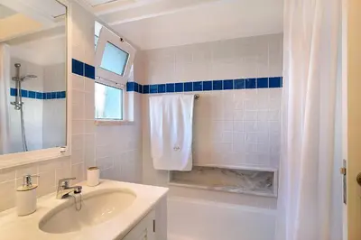 a bathroom with a sink and a tub and a shower at Bia in Almancil