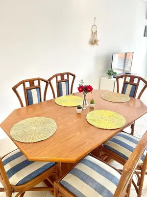 a wooden table with four chairs around it at Flat Luxuoso Praia da Oura in Albufeira